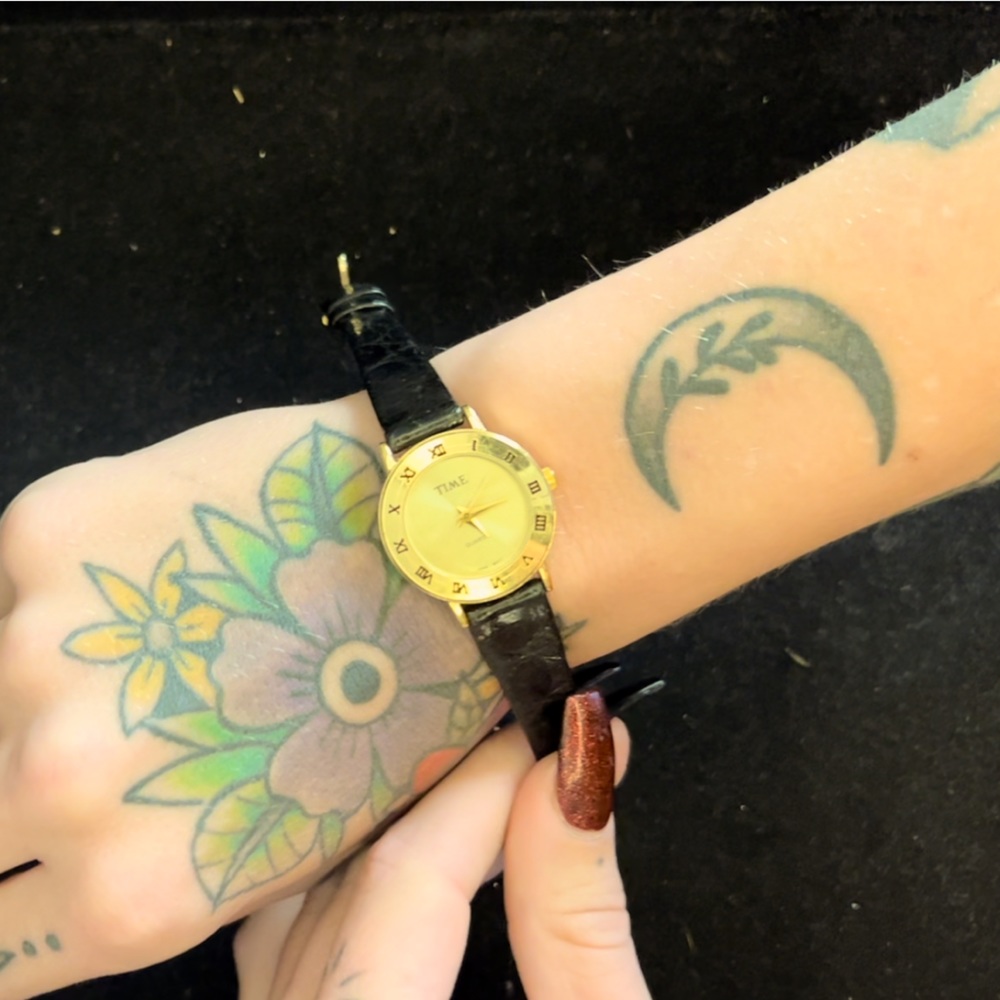 Womens black and gold “time” watch